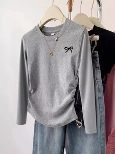 Minimalist grey long sleeve sweater tee with black bow print for casual holiday style