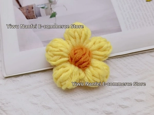 Detail of yellow and orange hand-knitted five-petal milk cotton crochet flower accessory