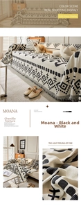Close-up of bohemian chenille sofa cover with black white geometric patterns and tassels