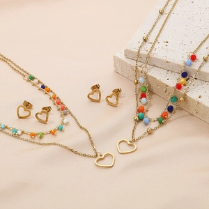Detail of bohemian gold jewelry sets with multi-layer heart necklaces and color beads