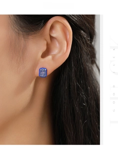 Detailed view of rectangular blue crystal stud earring worn on ear in 925 sterling silver