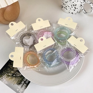 Set of colorful spiral telephone cord hair ties in various candy gradient colors