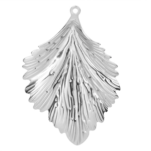 Macro detail of leaf-shaped stainless steel pendant with textured metallic veins