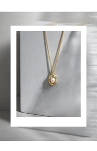 Detailed macro view of S925 sterling silver shell pearl pendant with modern liquid metal design