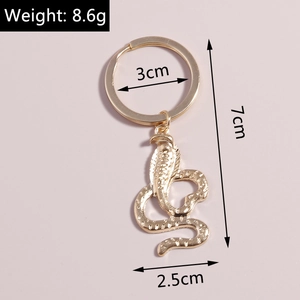 Golden cobra keychain with detailed scale texture and exact dimensions of 3x7x2.5 cm