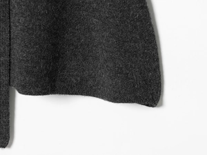 Vue macro de la texture de maille gris foncé avec détails d'ourlet soignés