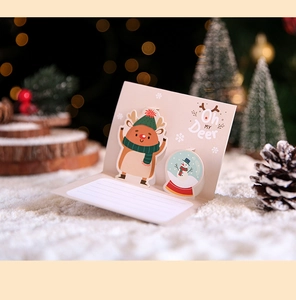 Detailed view of a 3D pop-up Christmas card featuring a cute reindeer and snowman design