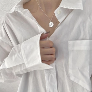 925 silver coin necklace featuring a round portrait medallion on a minimalist model