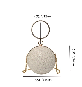 Detailed view of cream sphere clutch with diamond ring handle and dimensions 14cm