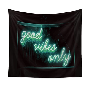 Detail view of modern black hanging tapestry with green neon Good Vibes Only text