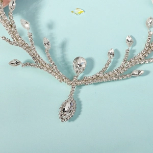 Close-up of bridal crystal forehead chain with intricate silver rhinestone branch details