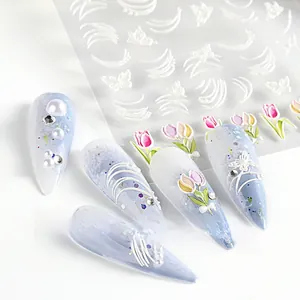 Macro view of 5D embossed nail art stickers with tulip, butterfly, and pearl textures