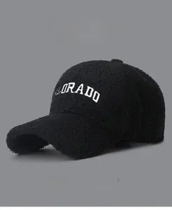 Detail of embroidered COLORADO lettering on warm black lamb wool baseball cap