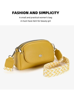 Close-up of yellow lychee leather dumpling bag with woven wide shoulder strap and silver zip