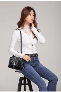 Close-up of black quilted bucket bag with gold hardware and elegant stitching detail