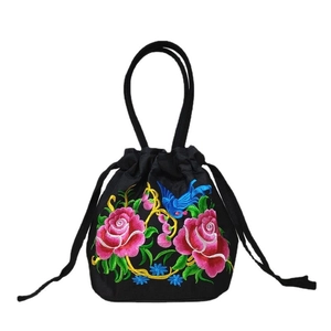 Ethnic style black canvas bucket bag featuring detailed rose embroidery and drawstring