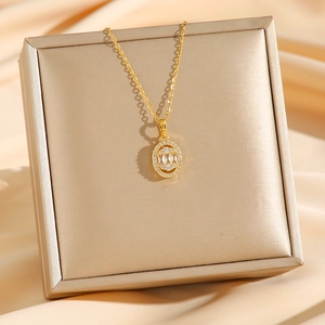 Elegant gold titanium steel necklace with oval pendant and rectangle zircon on silk background