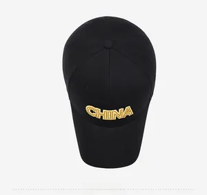 Top view of black cotton baseball cap featuring gold CHINA embroidery and 6-panel design