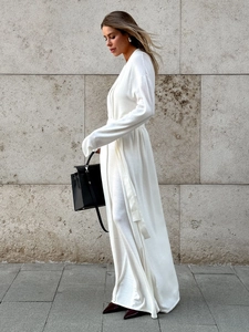 Detail of white knitted long sleeve cardigan and wrap dress set with waist tie