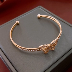 Detailed macro view of gold-plated butterfly bracelet featuring sparkling white zircon stones