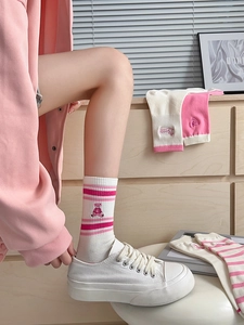 Detail of pink striped crew socks with cute bear embroidery made of premium cotton