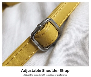 Close-up of yellow shoulder strap with silver adjustable metal buckle on crossbody bag