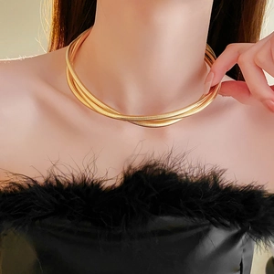 Gros plan détaillé du collier multi-rangs en chaîne serpent dorée sur un mannequin