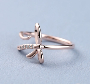 Macro view of rose gold bow ring featuring sparkling diamonds and polished finish
