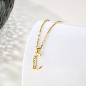 Close-up of 18K gold letter L pendant with zirconia inlay on stainless steel chain
