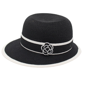 Elegant black and white straw cloche hat with camellia flower decoration