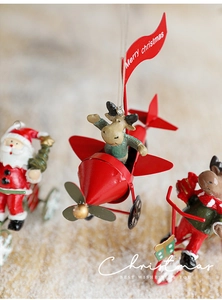 Detailed view of metal Santa and reindeer figurines on a plane and tricycle