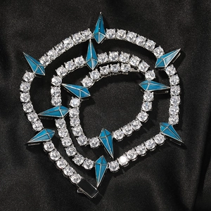 Macro detail of silver hip hop panther chain with blue accents and zircon inlay