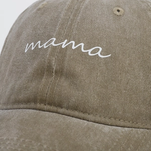 Detail of mama embroidery on a vintage washed khaki cotton baseball cap for women