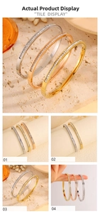 Detailed views of gold and silver steel bangles with micro-pave cubic zirconia inlay