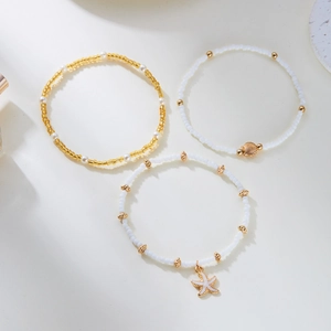 Detailed set of 3 bead bracelets featuring starfish charms, sea shells, and pearls