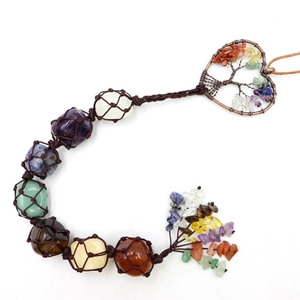 Close-up of handmade Tree of Life heart pendant with natural 7 chakra stones in rope mesh