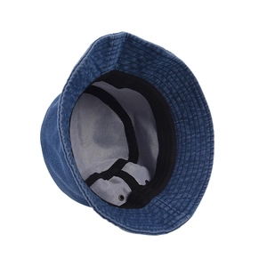 Detail of dark blue corduroy bucket hat showing inner lining and metal eyelet