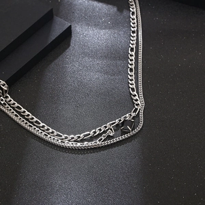 Multi-layer titanium steel necklace with black gemstone square pendant on a dark background