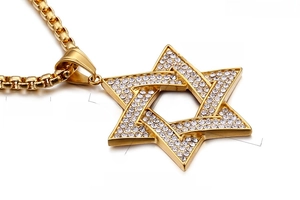Macro detail of iced-out star of david pendant with 18k gold plating and box chain