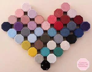 Top view of octagon velvet ring boxes arranged in a large heart shape with 40 colors