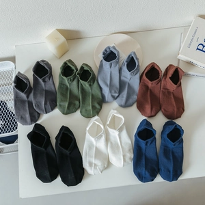 Flat lay of cotton invisible socks in seven assorted colors on a white surface