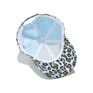 Macro view of leopard baseball cap interior with 100% cotton lining and cross straps