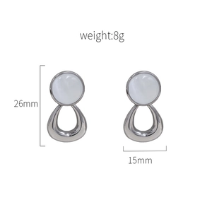 Silver geometric earrings with white cat's eye stone and teardrop cutout design