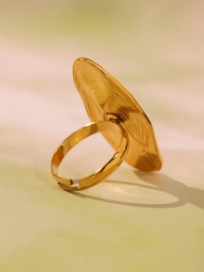 Detail of 18K gold plated ring with spiral texture and oval shell pearl setting