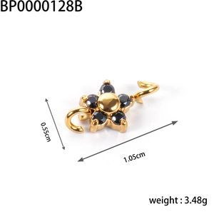 Macro detail of gold flower charm with black stones and technical size dimensions