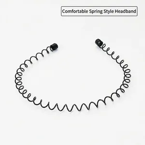 Macro detail of black metal spring headband with protective round tips and wave design