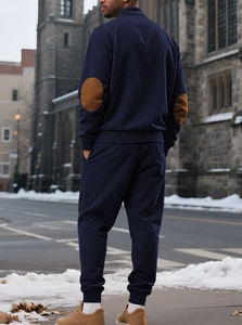 Outdoor shot of men's dark blue tracksuit with brown elbow patches and knit texture
