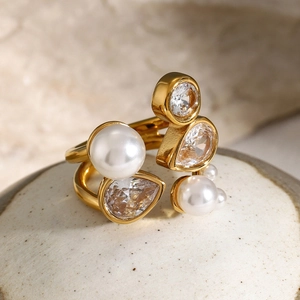 Macro shot of 18k gold stainless steel open ring with white pearls and drop zircon stones