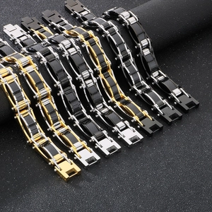 Detailed view of various mechanical steel bracelets in black, gold, and silver finishes