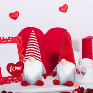 Detail of two Valentine gnomes holding Be Mine and Kiss Me hearts in a romantic setting